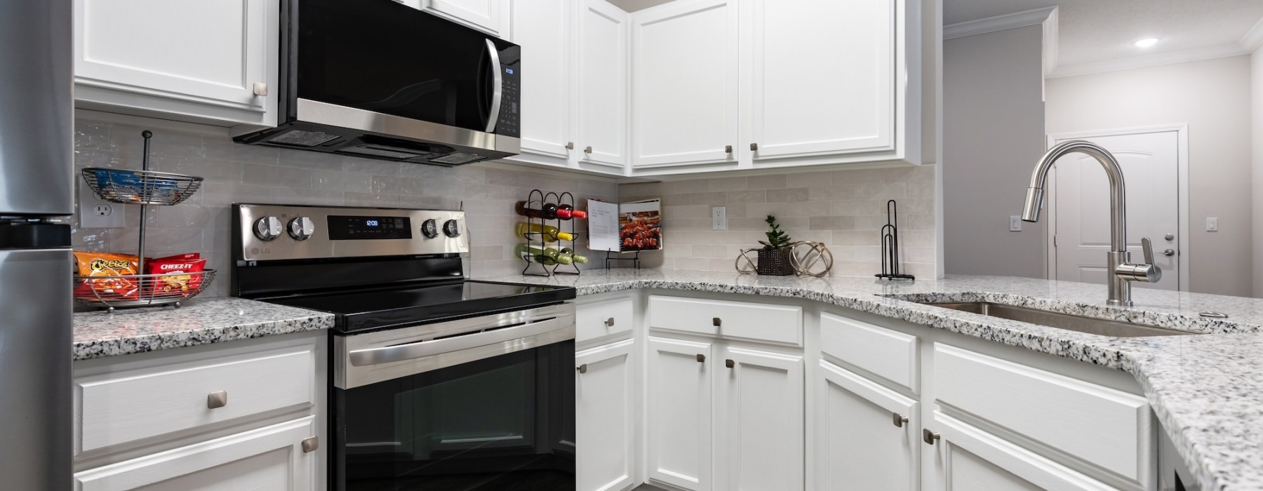 a kitchen with white cabinets