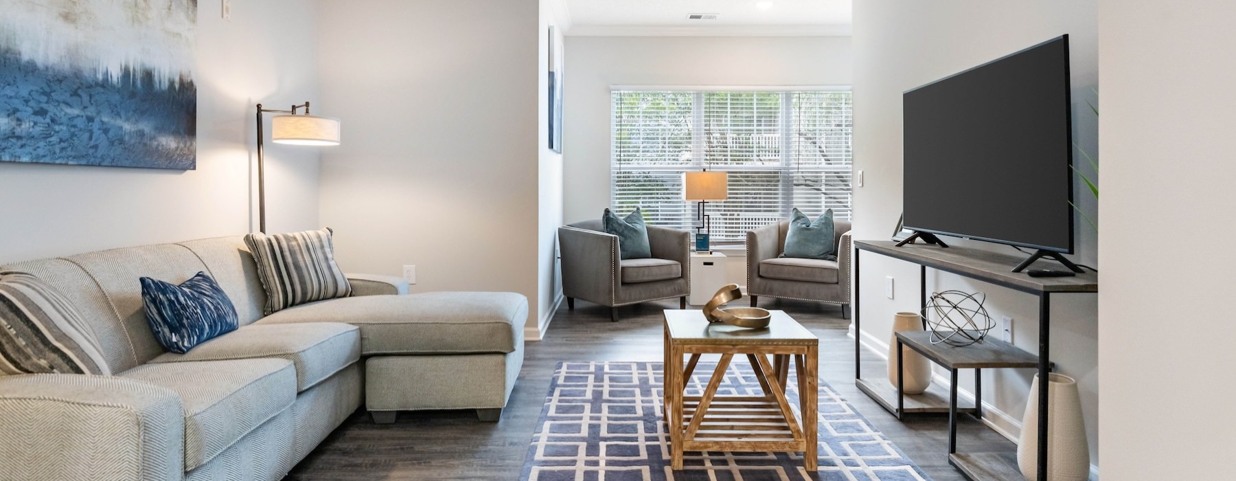 a living room with a couch, table and tv