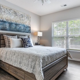 a bedroom with a bed and two nightstands