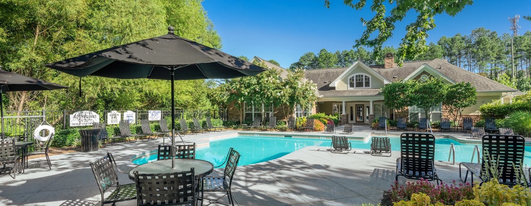 a pool with chairs and umbrellas